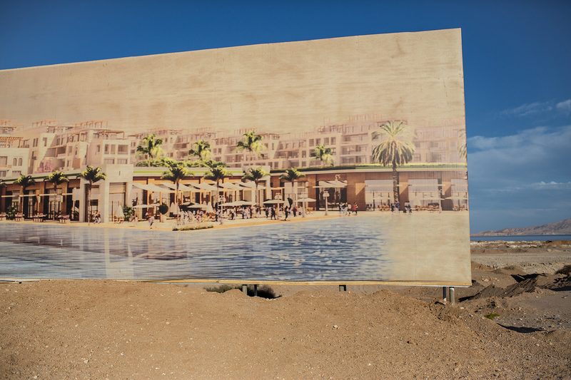 A faded billboard at the entrance to a new hotel construction site (Photo: Chris McGrath/Getty Images)
